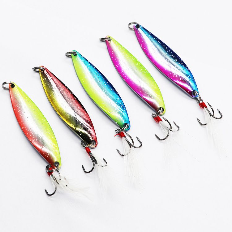 Five metal spoon lures in different colours with white feathered hooks