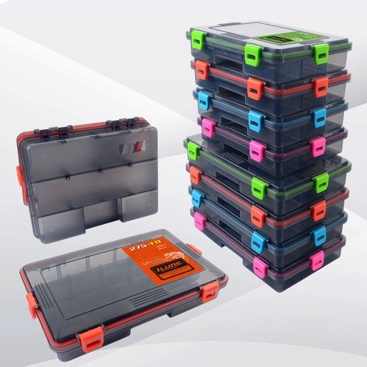 A stack of lure boxes in orange, pink, blue and green clips